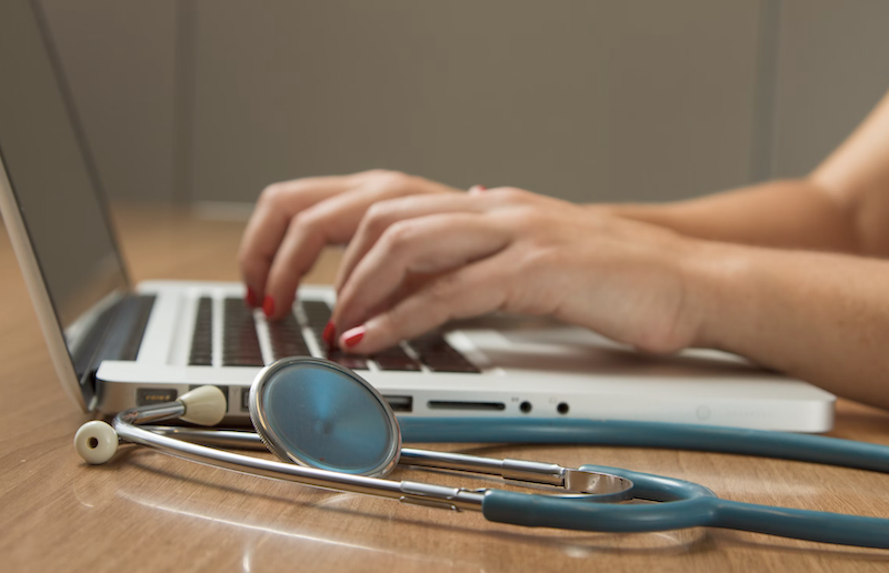 laptop and stethoscope representing medical diagnosis