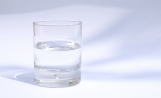 a water glass half full to represent optimism