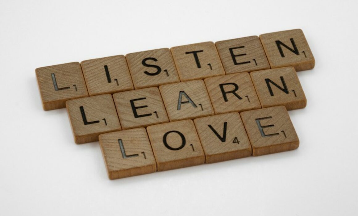 listen, learn, love written out in scrabble tiles