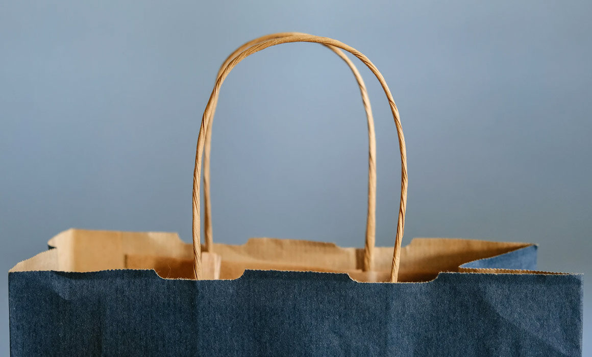 The handles of a shopping bag.