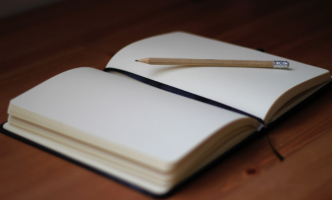A blank notebook and pencil