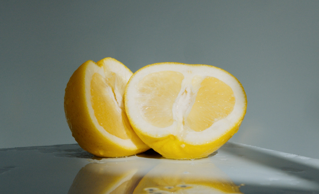 Close up of a bright yellow lemon sliced in half