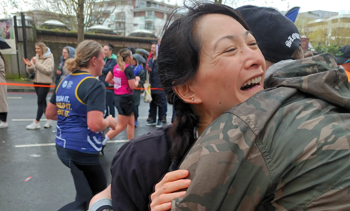 Michelle hugging supporters on the course of the Marathon