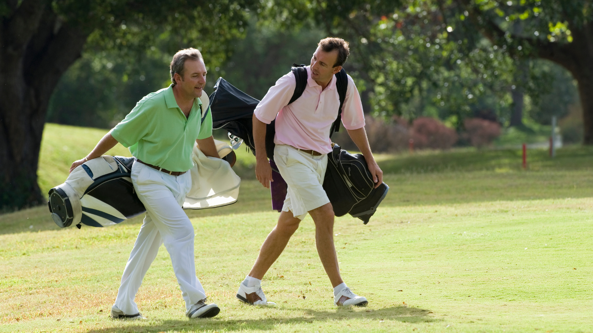 Golfers on the course carrying their bags
