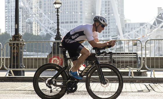 A cyclist competing in the Challenge London Triathlon to raise money for Future Dreams breast cancer charity