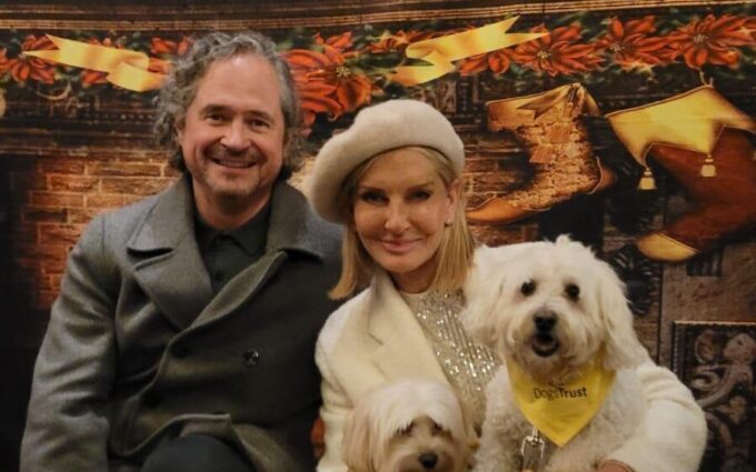 Jacquie and her husband looking festive with a dog